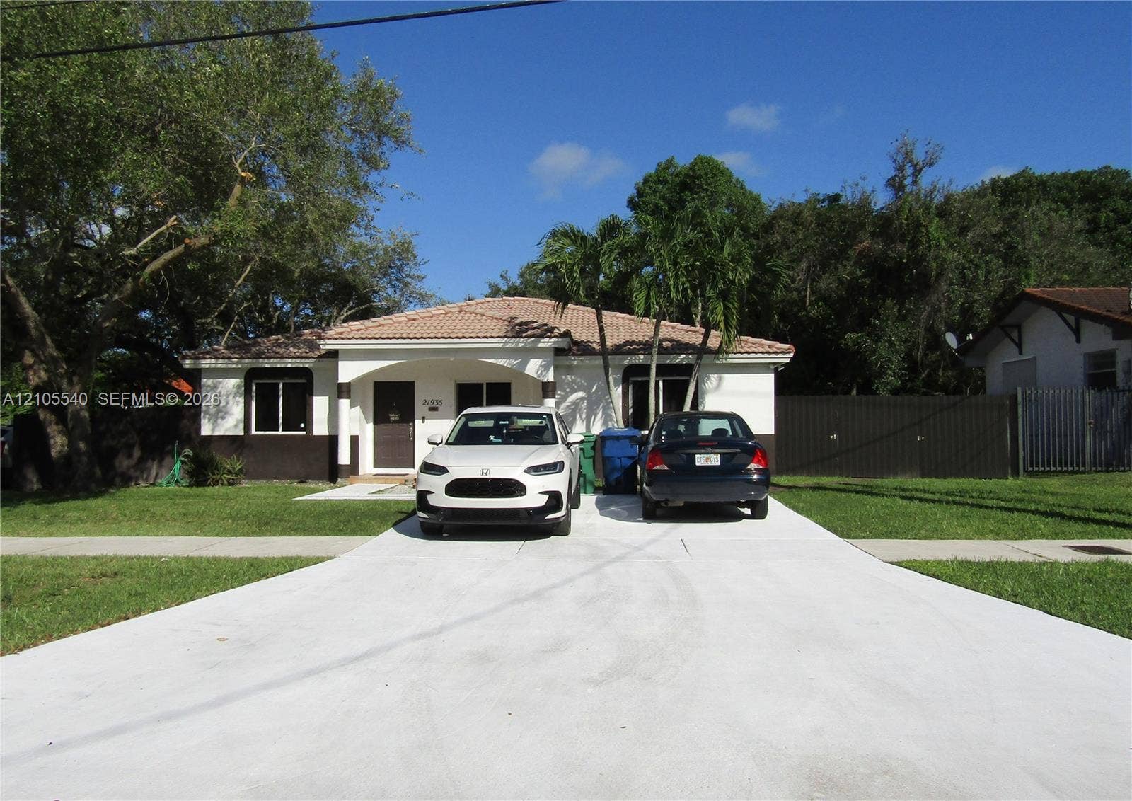 21935 SW 102nd Avenue, Cutler Bay, FL 33190 Exterior with a tile roof, covered entry, and a concrete driveway