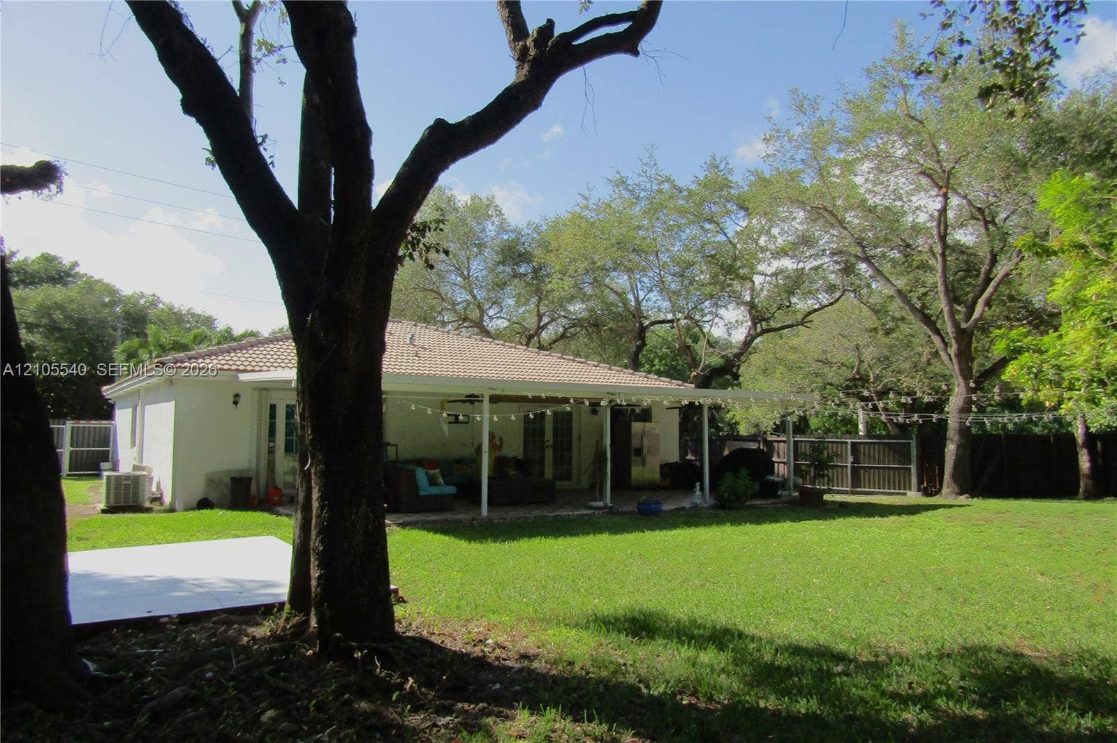 21935 SW 102nd Avenue, Cutler Bay, FL 33190 Expansive lawn with mature trees and a fenced perimeter