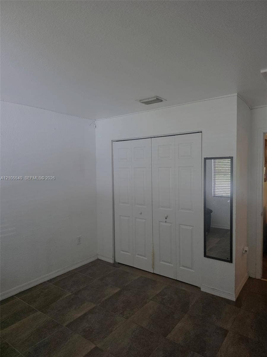21935 SW 102nd Avenue, Cutler Bay, FL 33190 White bi-fold doors with panel detailing