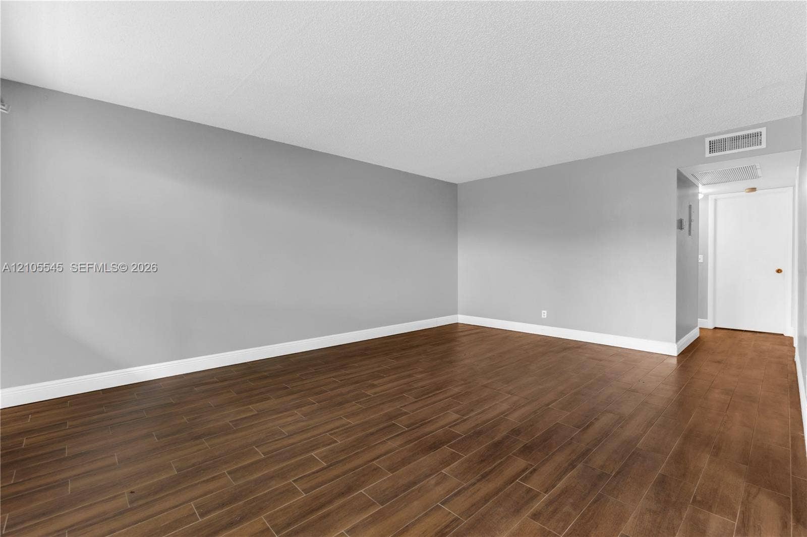 222 Tilford A, #222, Deerfield Beach, FL 33442 Wood-finish ceramic flooring throughout, complemented by neutral gray wall tones and crisp white trim