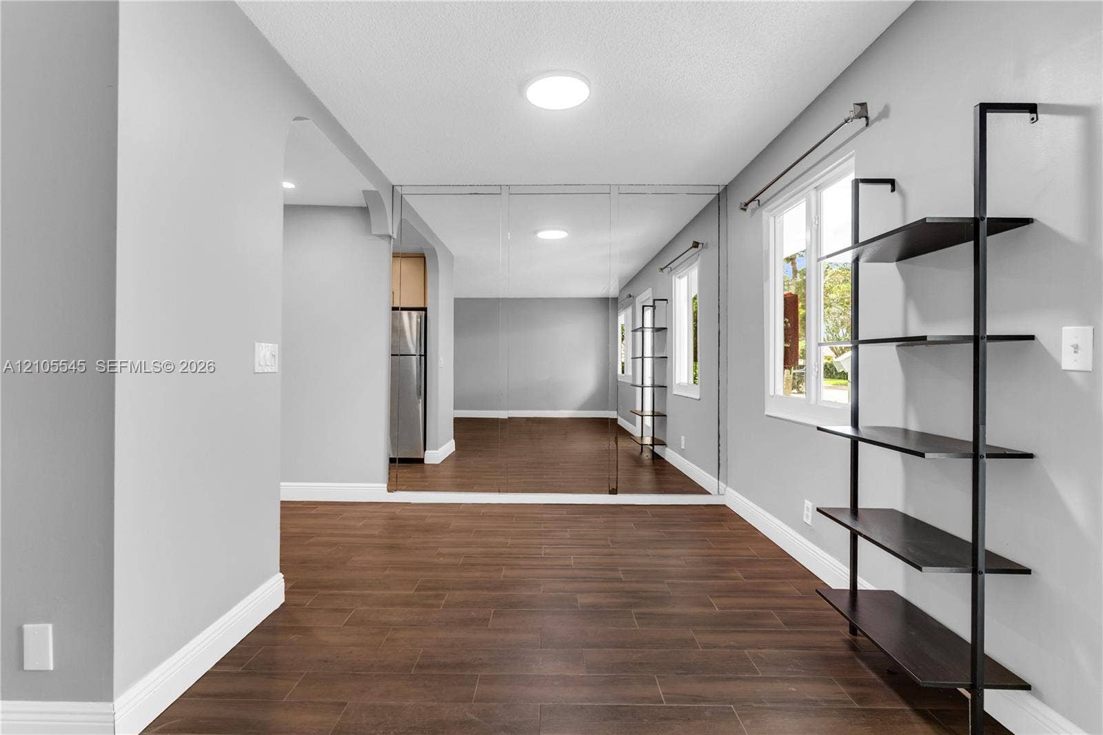 222 Tilford A, #222, Deerfield Beach, FL 33442 Recessed lighting, full-height wall mirror, wood-finish flooring, built-in shelving, and white trim