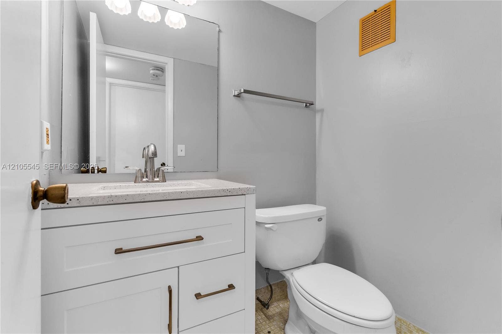 222 Tilford A, #222, Deerfield Beach, FL 33442 White vanity with bronze hardware, a white countertop, and a chrome faucet