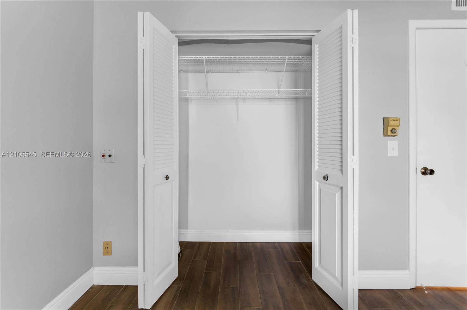 222 Tilford A, #222, Deerfield Beach, FL 33442 Louvered bi-fold closet doors revealing wire shelving