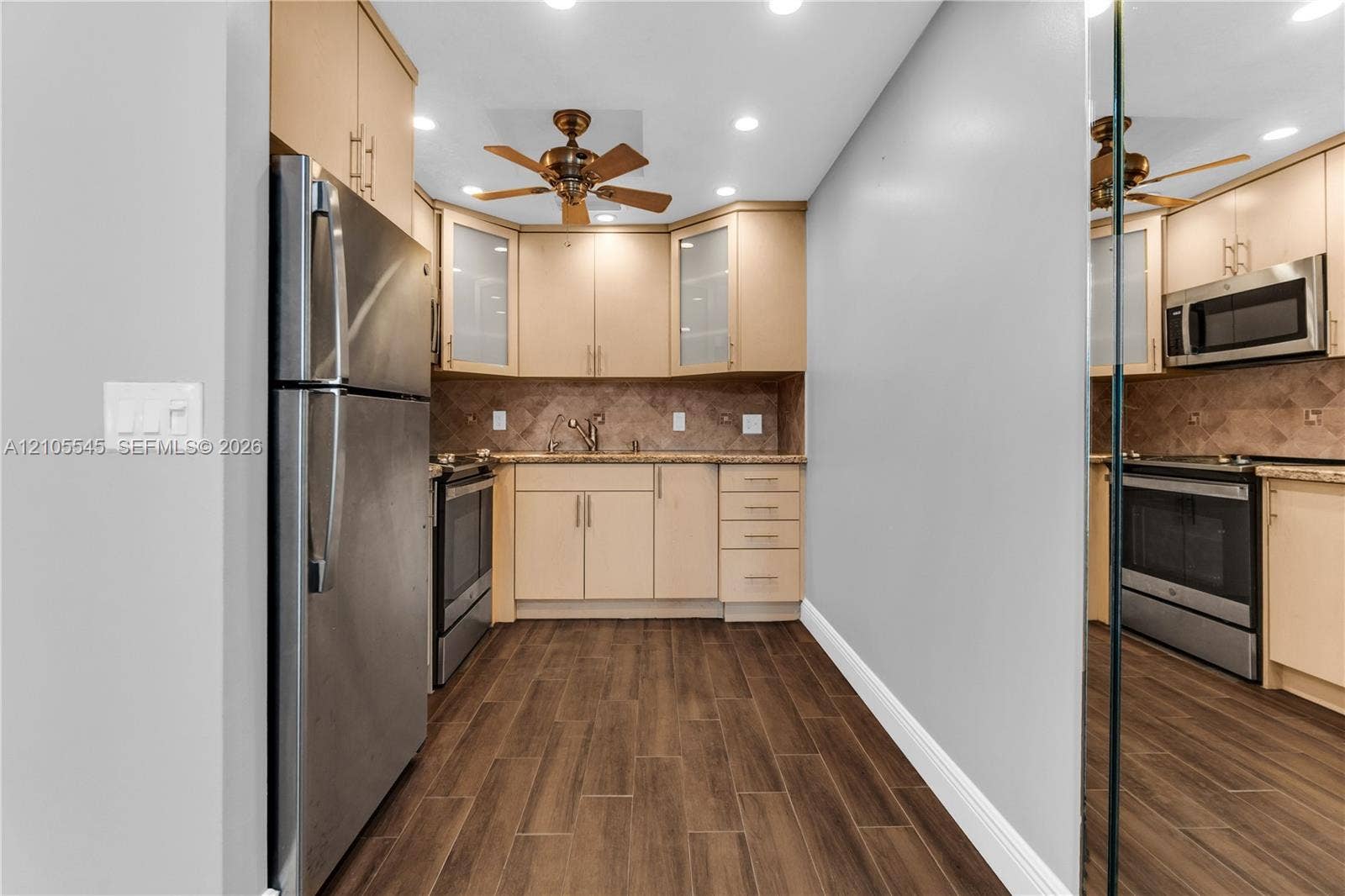 222 Tilford A, #222, Deerfield Beach, FL 33442 Kitchen featuring stainless steel appliances, wood-finish flooring, recessed lighting, a ceiling fan, and ample cabinetry