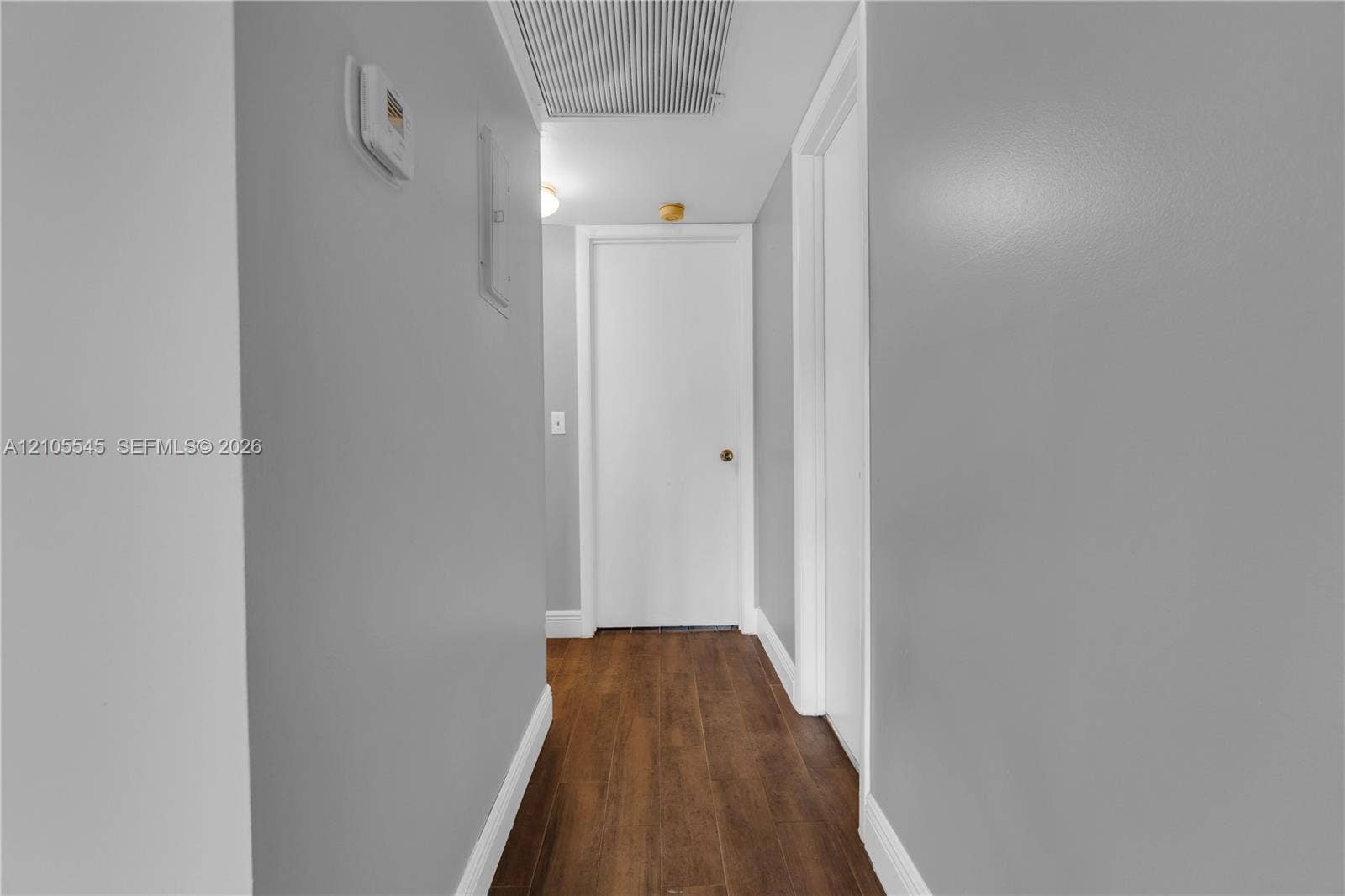 222 Tilford A, #222, Deerfield Beach, FL 33442 Hallway with wood-finish ceramic flooring, light gray wall paint, and white trim