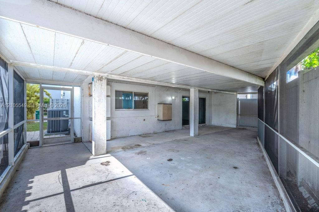 Screened patio with a concrete floor and a solid roof