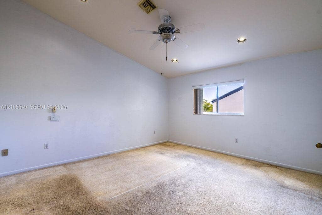 Vaulted ceiling with a ceiling fan, recessed lighting, and a single window