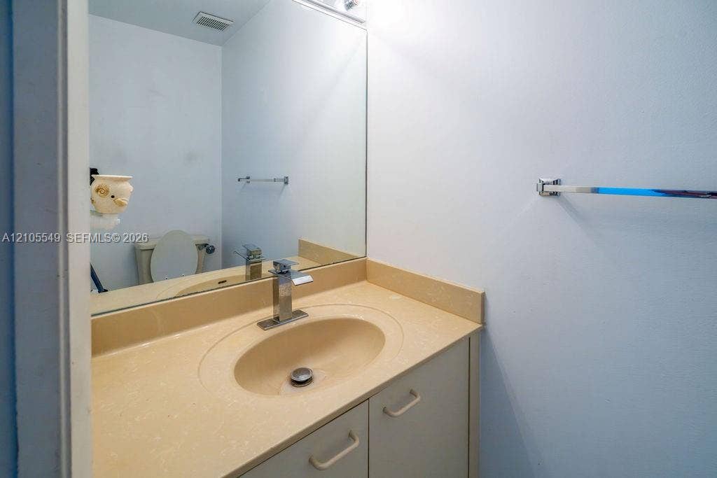 Built-in vanity with a composite countertop and integrated oval sink