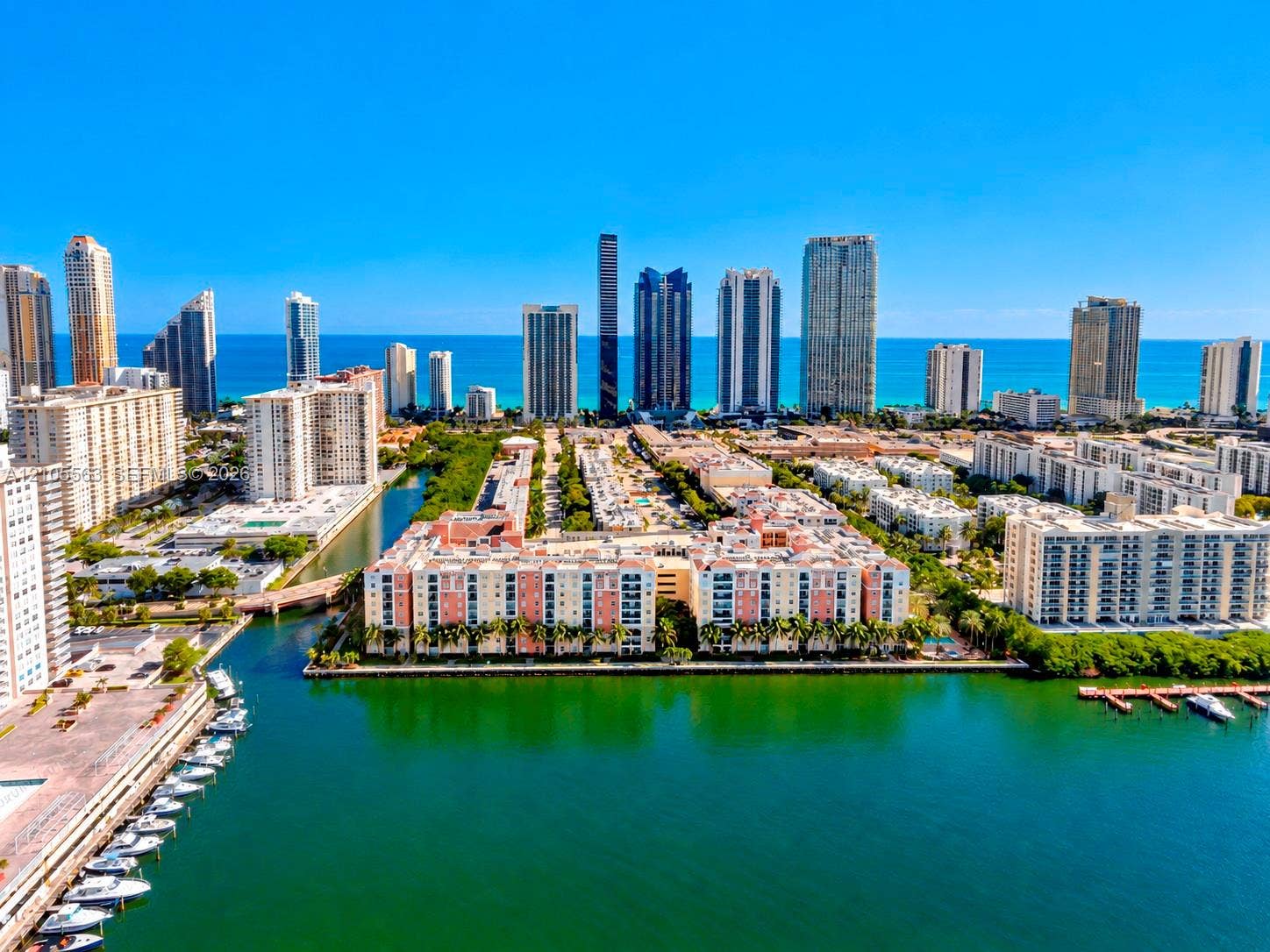 17145 N Bay Road, #4613, Sunny Isles Beach, Sunny Isles Beach, FL 33160 Coastal skyline featuring multiple high-rise buildings, a marina with docked boats, and waterways