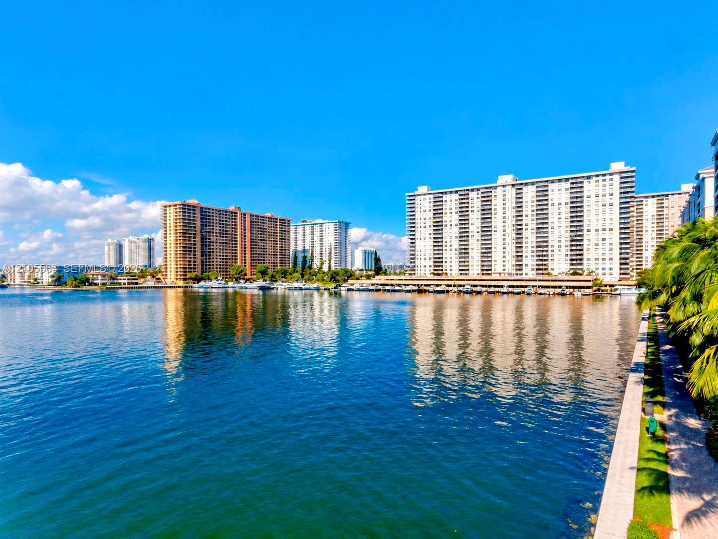 17145 N Bay Road, #4613, Sunny Isles Beach, Sunny Isles Beach, FL 33160 Waterfront high-rise residence showcasing panoramic water vistas, direct waterfront access, multi-building residential complex with varied architectural styles, lush tropical landscaping along the promenade, and sparkling blue-water setting with natural light throughout