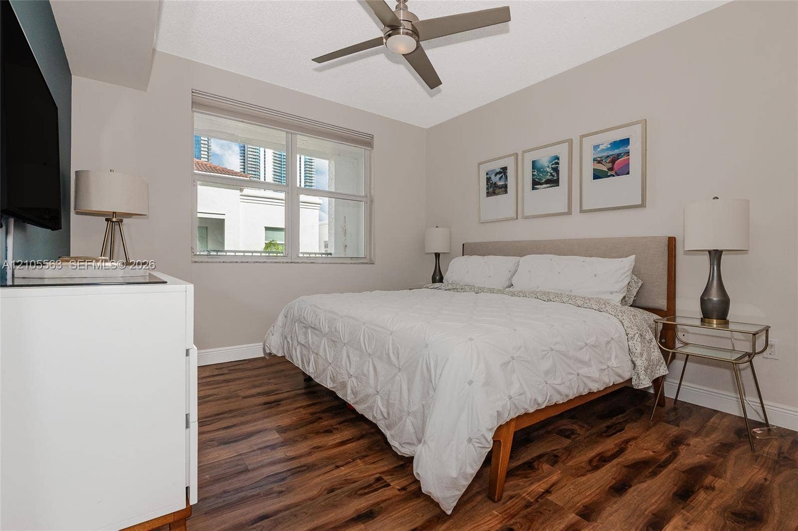 17145 N Bay Road, #4613, Sunny Isles Beach, Sunny Isles Beach, FL 33160 Wood-finish flooring with a neutral wall color, overhead ceiling fan, and a large window