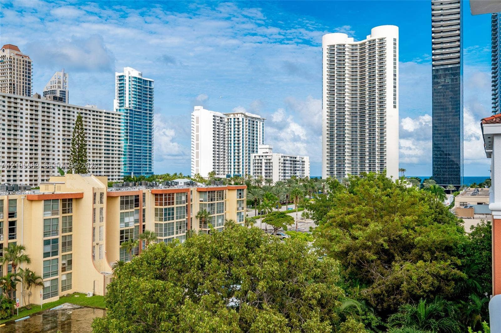 17145 N Bay Road, #4613, Sunny Isles Beach, Sunny Isles Beach, FL 33160 Elevated urban and coastal scenery featuring multiple high-rise buildings and mature tropical landscaping