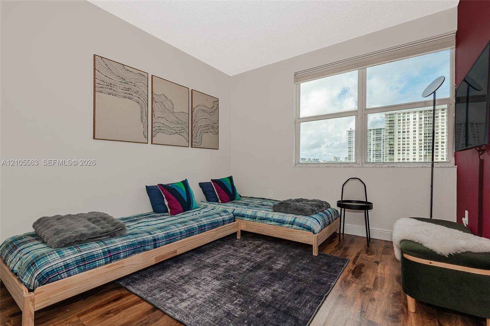 17145 N Bay Road, #4613, Sunny Isles Beach, Sunny Isles Beach, FL 33160 Wood-finish flooring, white walls, and a large window with roller shades