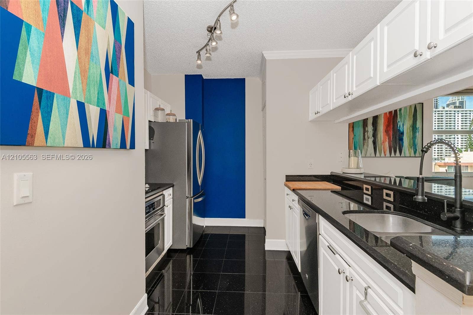 17145 N Bay Road, #4613, Sunny Isles Beach, Sunny Isles Beach, FL 33160 Kitchen featuring white cabinetry, black countertops, a stainless steel refrigerator, and a stainless steel oven