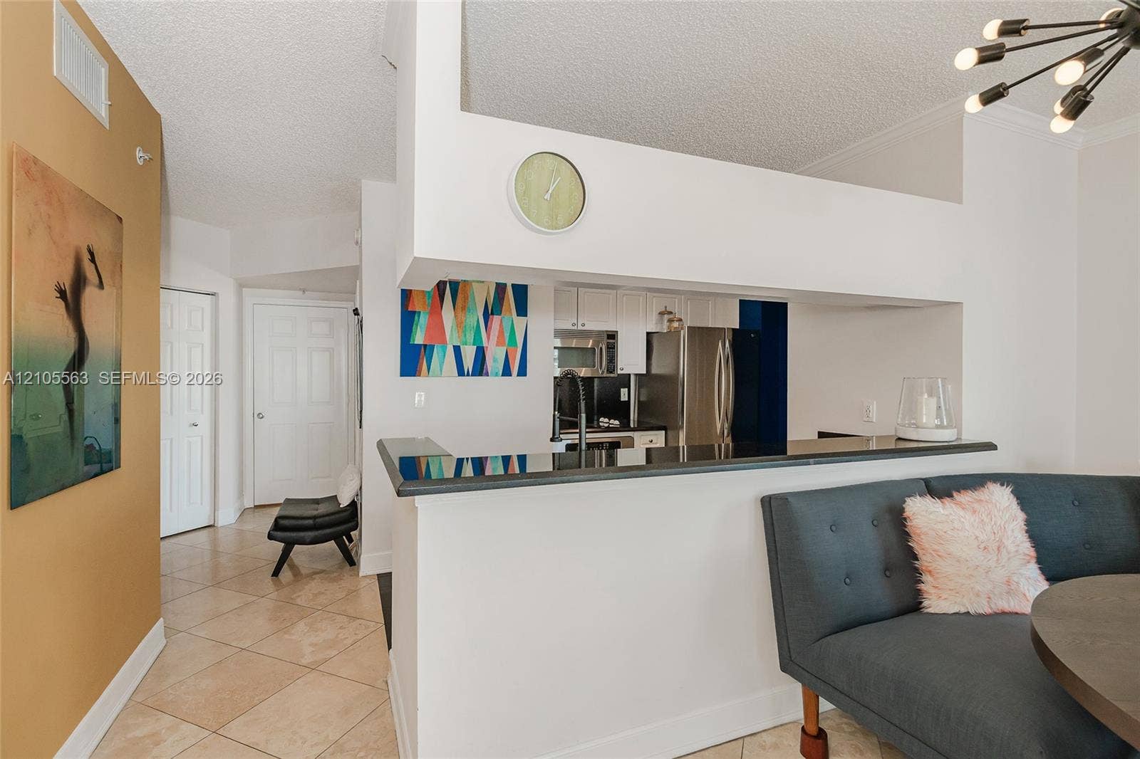 17145 N Bay Road, #4613, Sunny Isles Beach, Sunny Isles Beach, FL 33160 Kitchen pass-through with dark countertops, white cabinetry, and stainless steel appliances