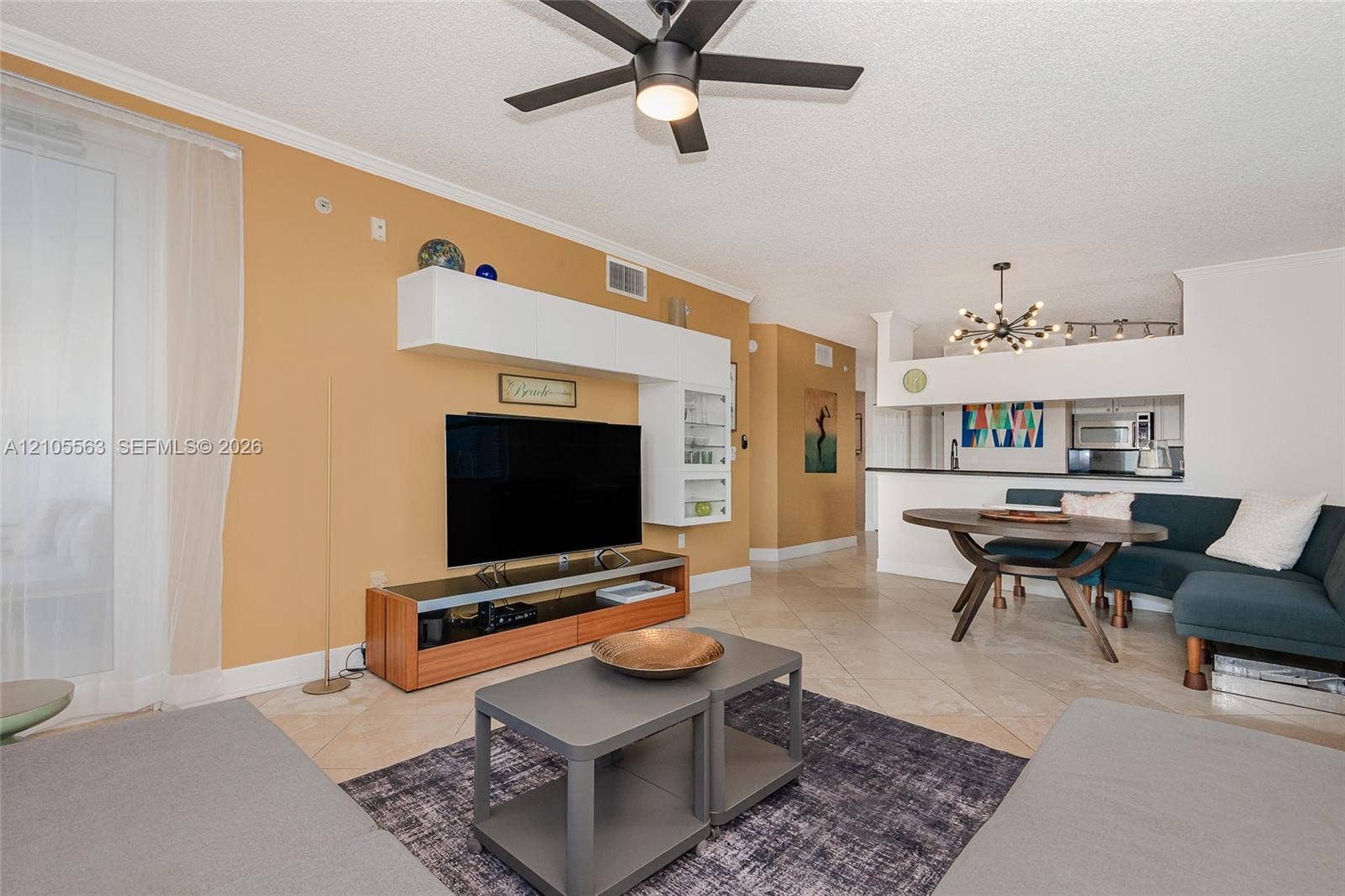 17145 N Bay Road, #4613, Sunny Isles Beach, Sunny Isles Beach, FL 33160 Open-concept living area featuring a built-in media center, ceiling fan, and tile flooring