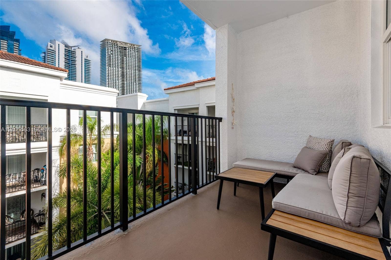 17145 N Bay Road, #4613, Sunny Isles Beach, Sunny Isles Beach, FL 33160 Private balcony featuring a textured wall finish and a black metal railing