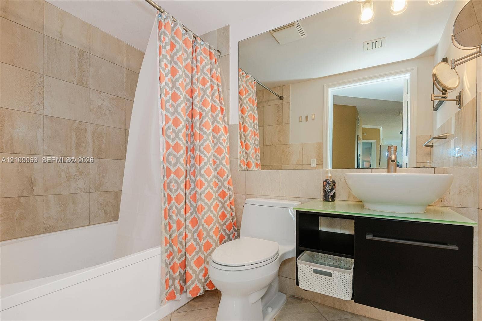 17145 N Bay Road, #4613, Sunny Isles Beach, Sunny Isles Beach, FL 33160 Bathroom featuring a ceramic tile shower surround, a white bathtub, and a modern vanity with a vessel sink and glass countertop