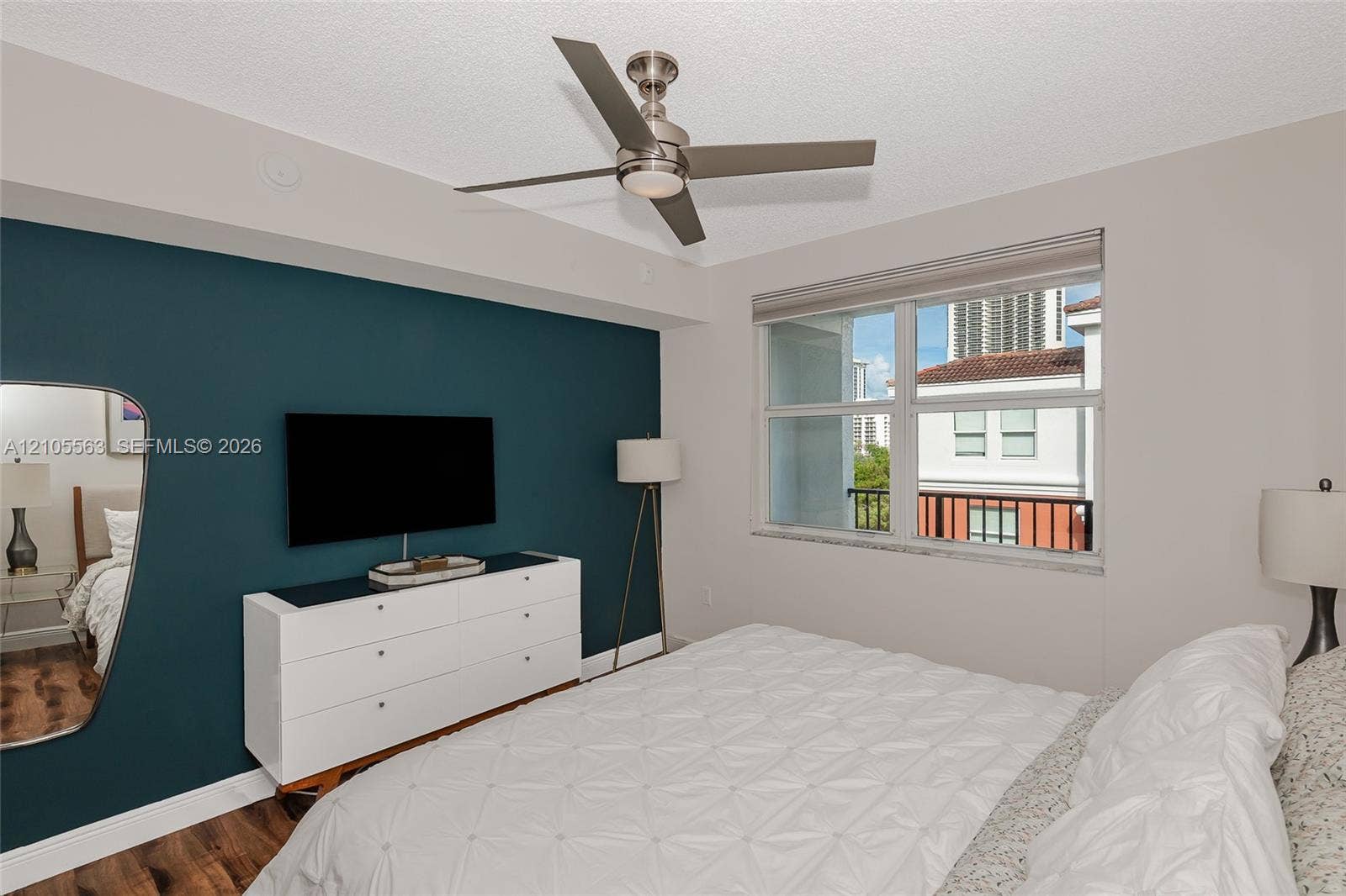 17145 N Bay Road, #4613, Sunny Isles Beach, Sunny Isles Beach, FL 33160 Contemporary bedroom with a window, wood-finish flooring, and a ceiling fan