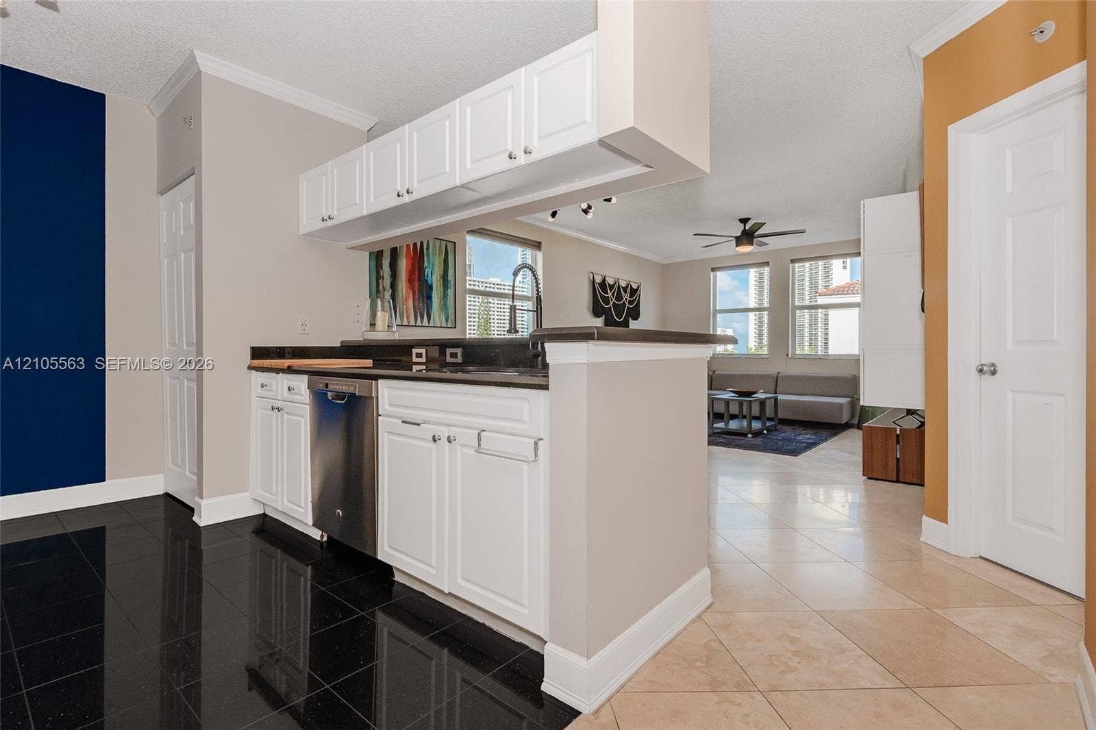 17145 N Bay Road, #4613, Sunny Isles Beach, Sunny Isles Beach, FL 33160 Kitchen featuring white cabinetry, black countertops, stainless steel dishwasher, and black tile flooring