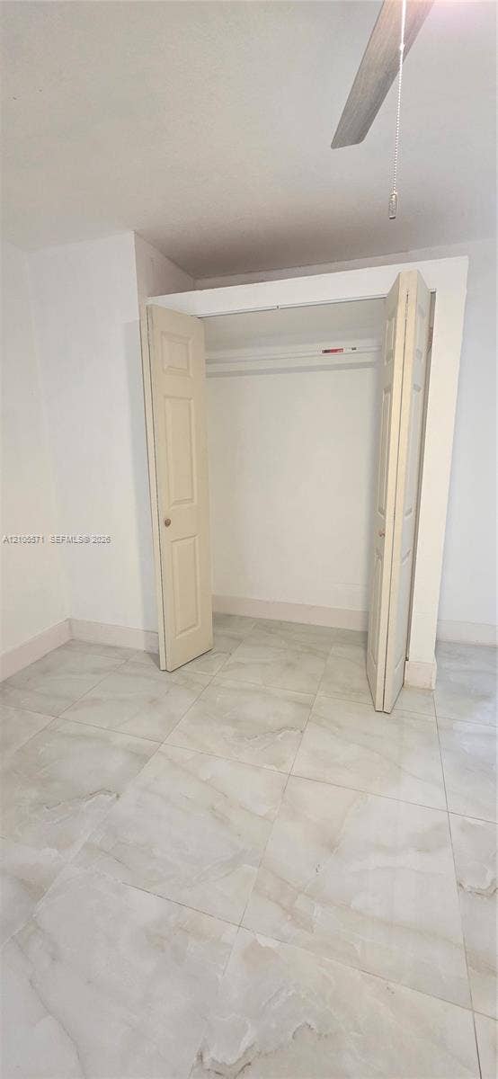 Recessed closet with bi-fold doors and interior hanging rod