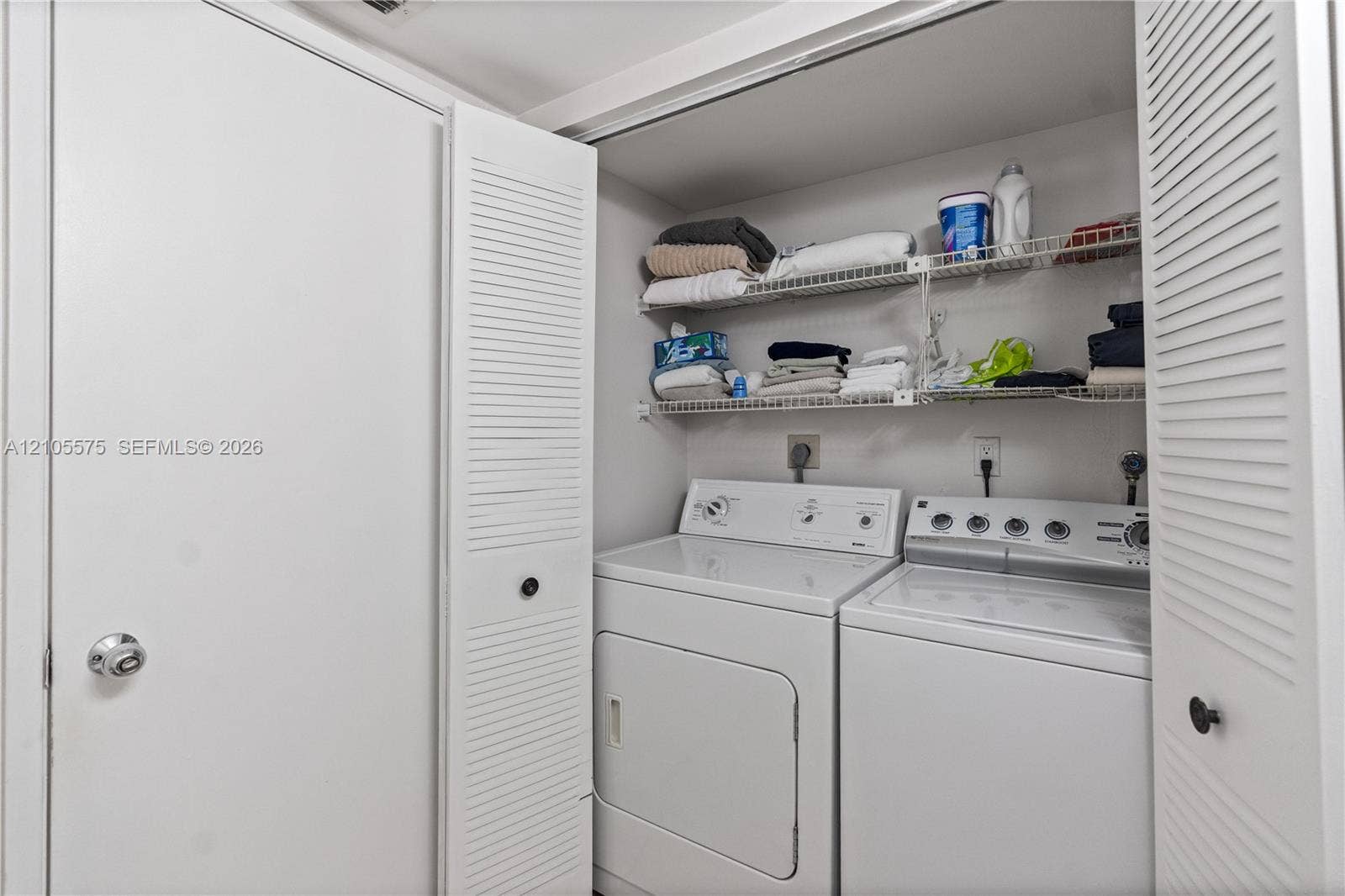 Convenient guest powder room and in-unit washer and dryer, providing everyday comfort and functionality at Mystic Pointe in Aventura.