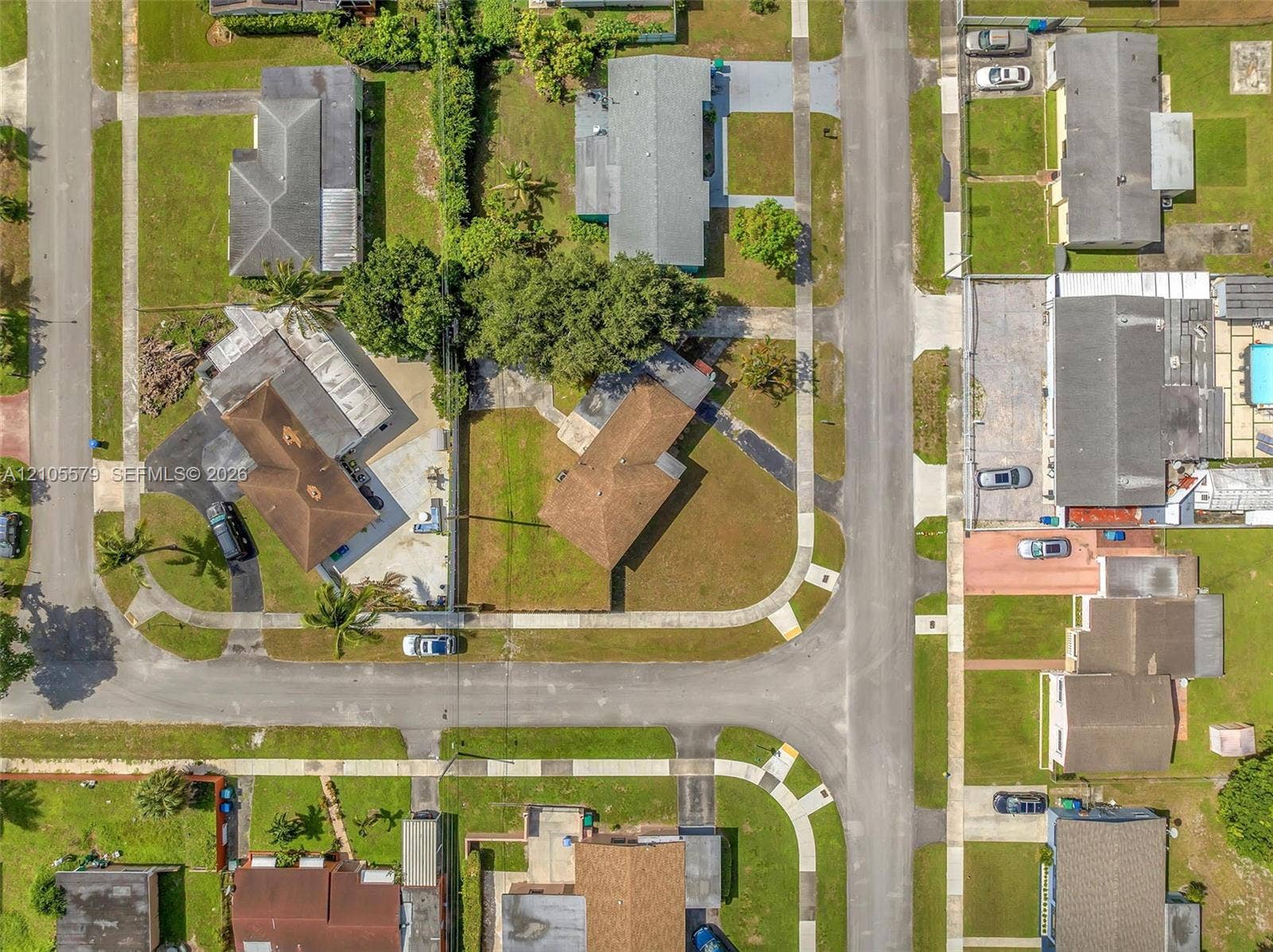 1750 NW 185th Street, Miami Gardens, FL 33056 Aerial perspective featuring a corner lot orientation, paved street frontage, concrete sidewalks, and established landscaping