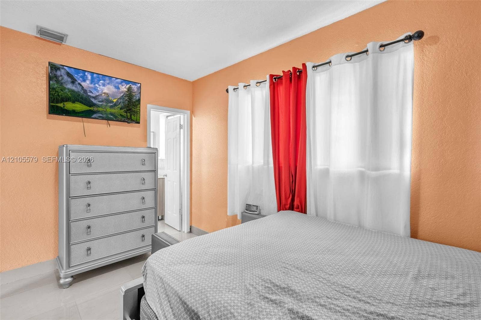 1750 NW 185th Street, Miami Gardens, FL 33056 Room featuring neutral-toned walls, tiled flooring, and a multi-panel interior door