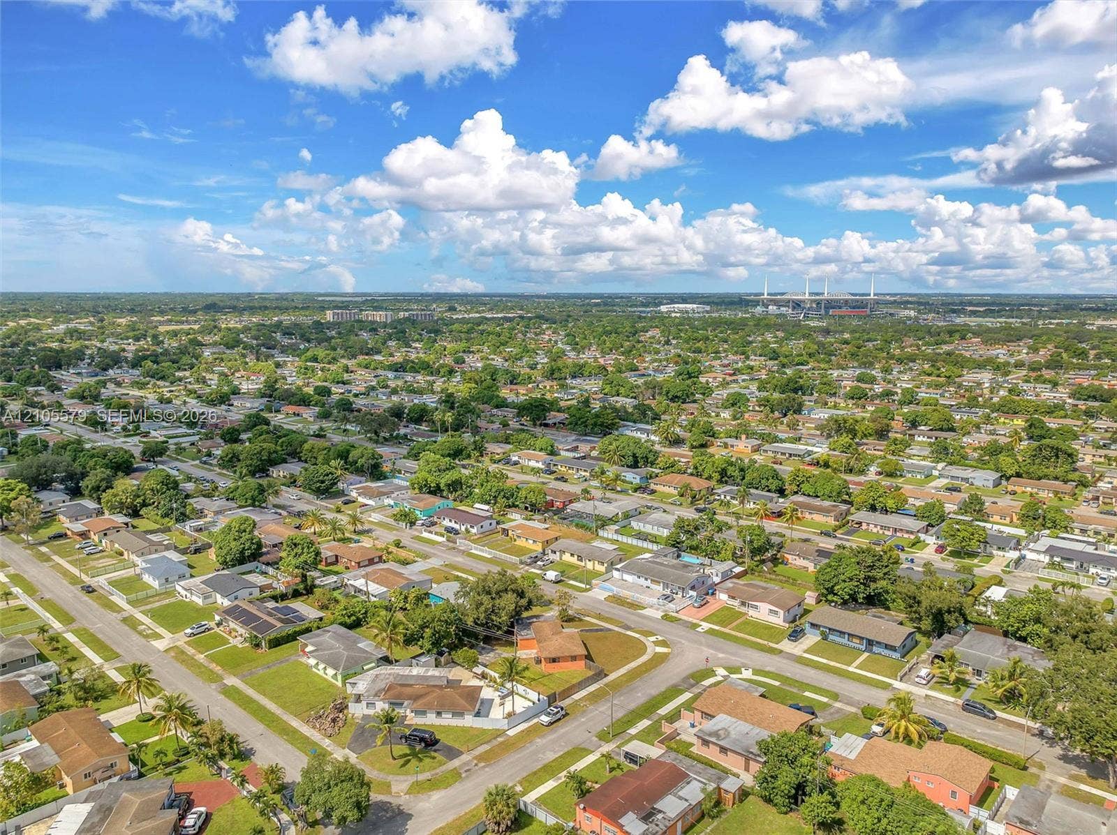 1750 NW 185th Street, Miami Gardens, FL 33056 Aerial perspective of a residential landscape featuring mature trees, grid-patterned streets, single-story structures, and expansive green space