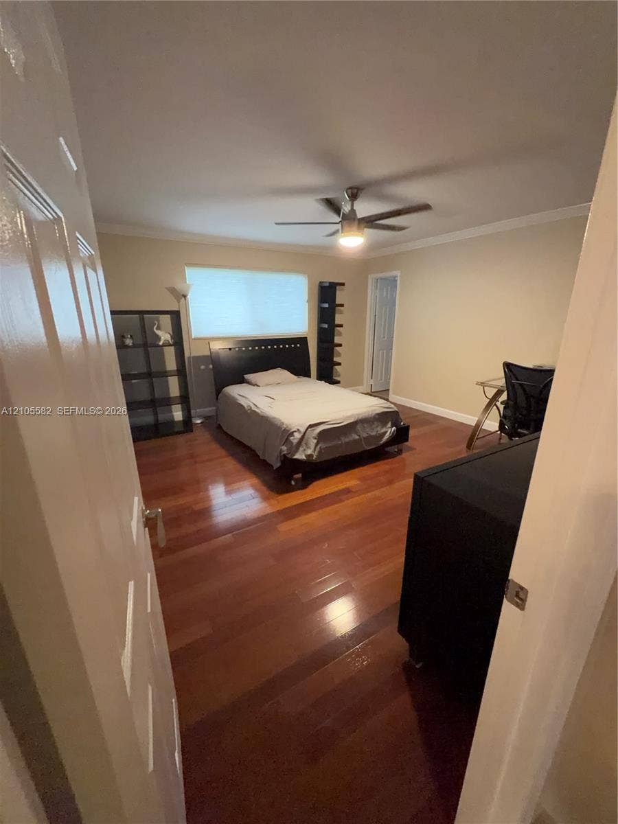 2215 NE 204th Street, Miami, Miami, FL 33180 Hardwood flooring, crown molding, ceiling fan with integrated lighting, and neutral wall paint