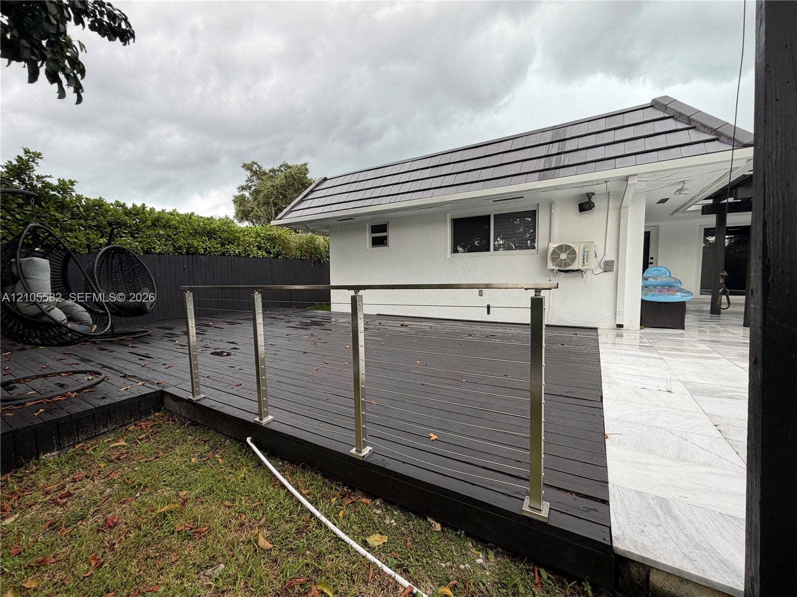 2215 NE 204th Street, Miami, Miami, FL 33180 Expansive outdoor deck featuring dark wood-finish planking and stainless steel railings