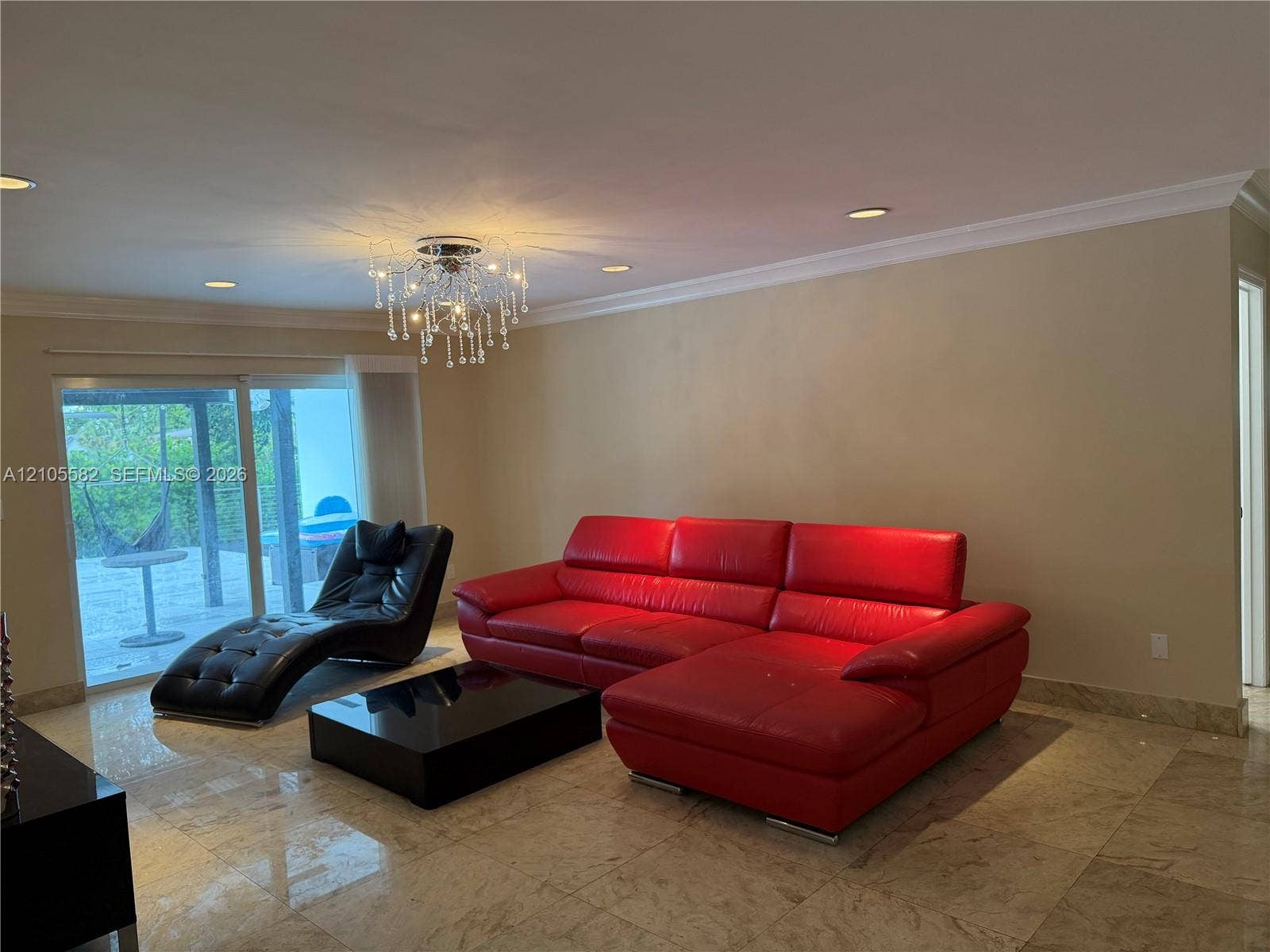 2215 NE 204th Street, Miami, Miami, FL 33180 Polished stone tile flooring, crown molding, recessed ceiling lighting, and a decorative chandelier