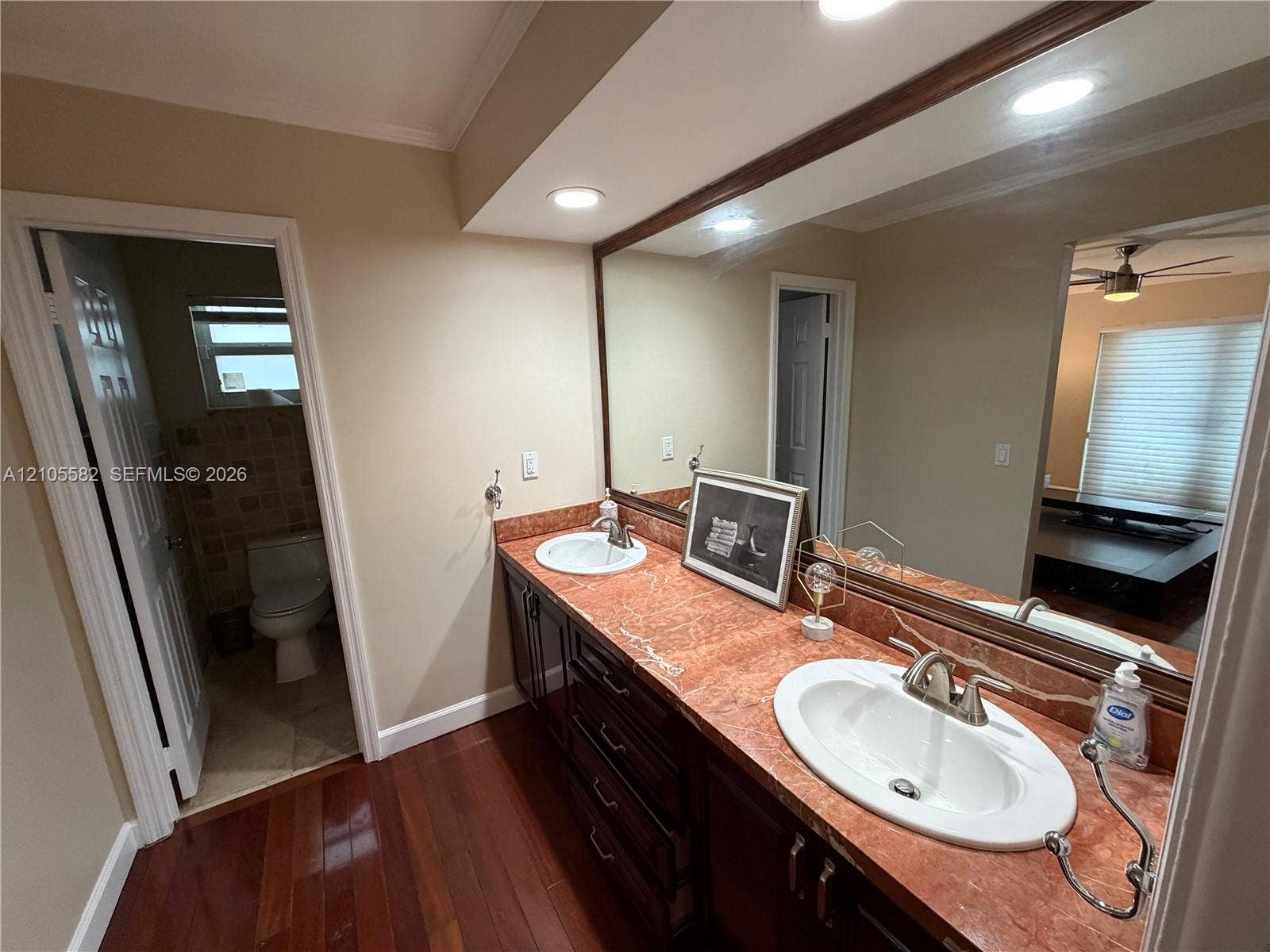 2215 NE 204th Street, Miami, Miami, FL 33180 Double vanity with integrated sinks, rich wood-finish cabinetry, and recessed lighting