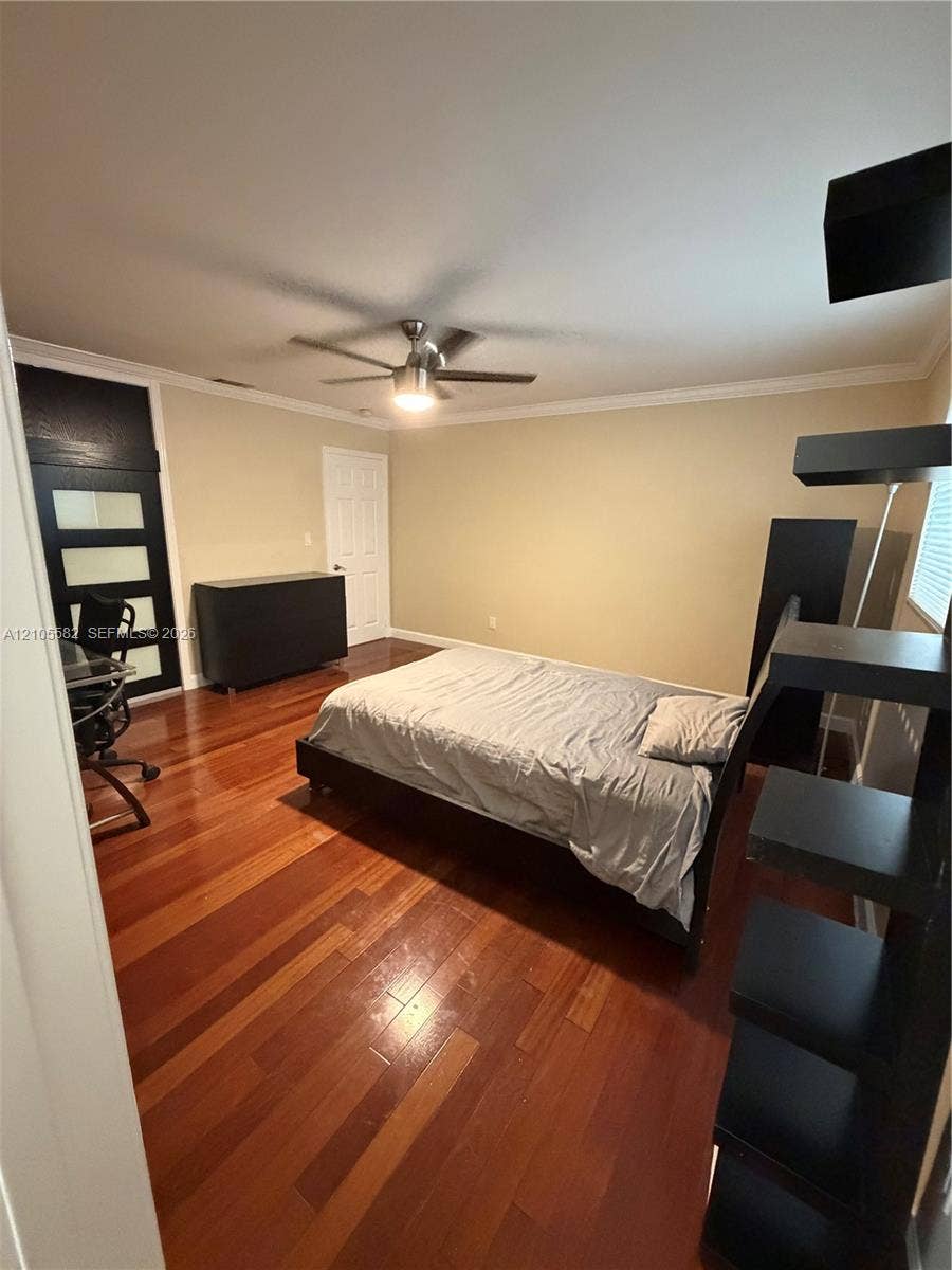 2215 NE 204th Street, Miami, Miami, FL 33180 Hardwood flooring throughout, ceiling fan with integrated lighting, crown molding, and a solid door with horizontal glass panels