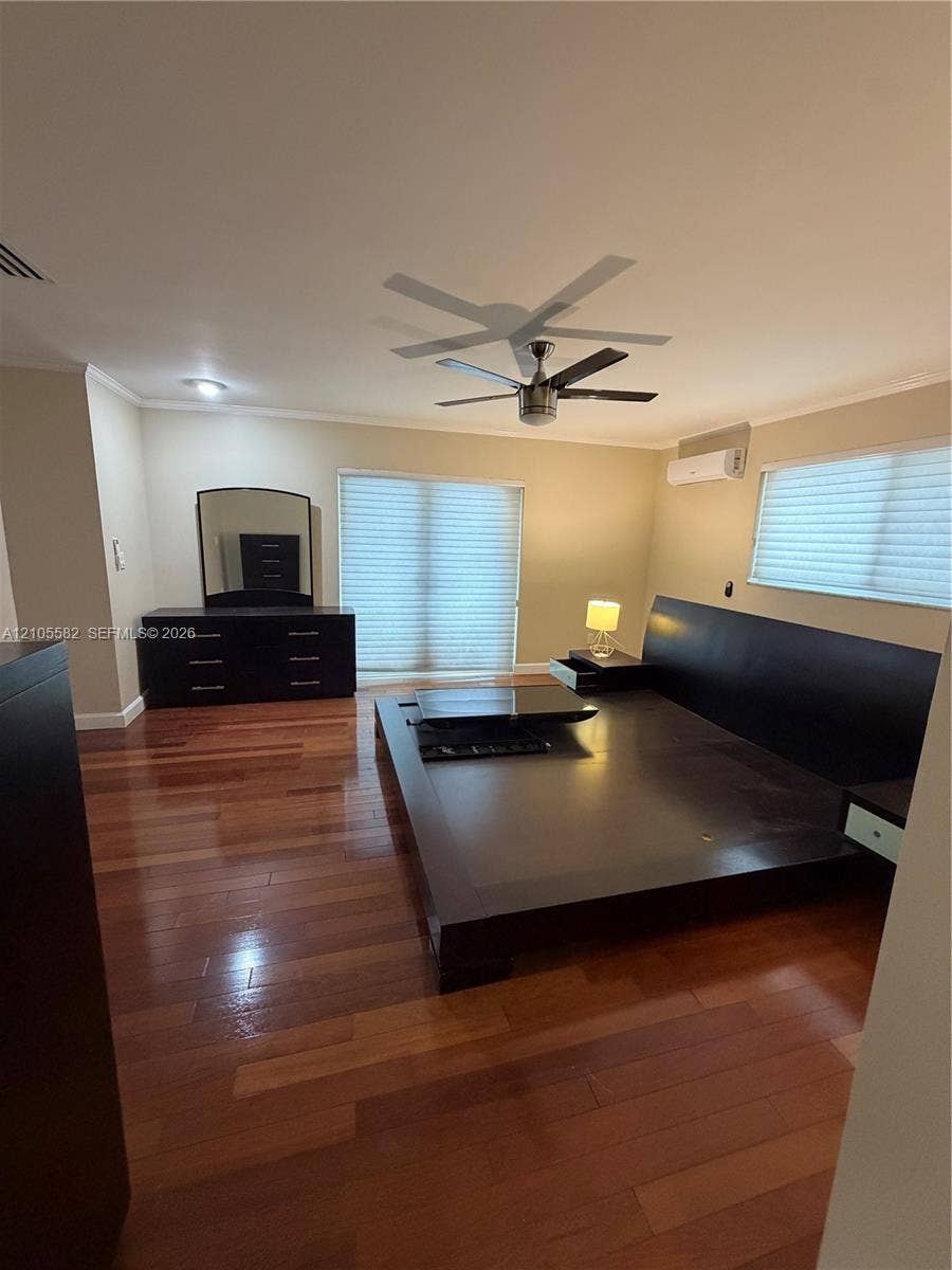 2215 NE 204th Street, Miami, Miami, FL 33180 Wood-finish flooring, dual ceiling fans, recessed lighting, and wall-mounted air conditioning unit