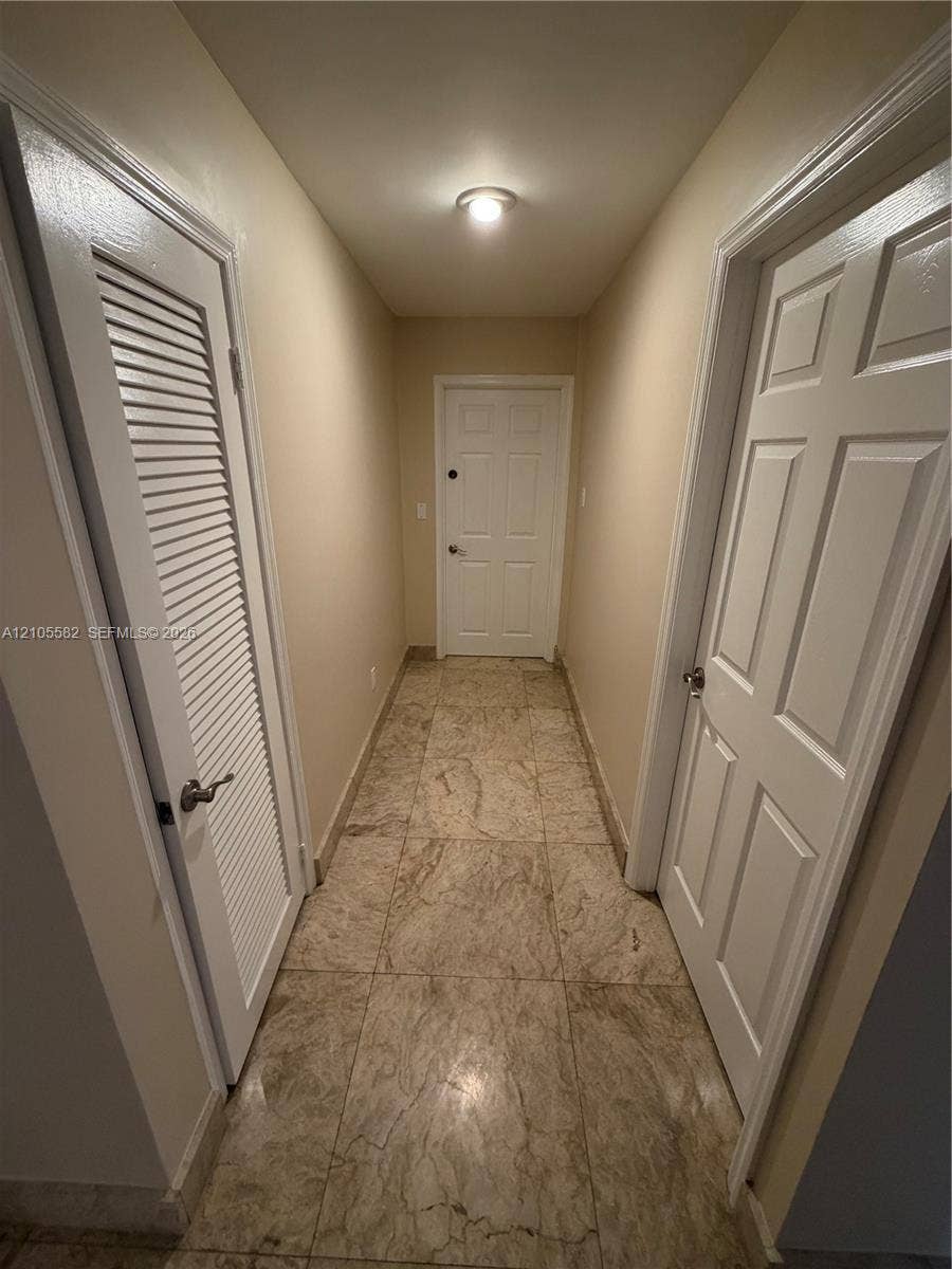 2215 NE 204th Street, Miami, Miami, FL 33180 Hallway featuring square tile flooring, neutral wall tones, and recessed ceiling lighting