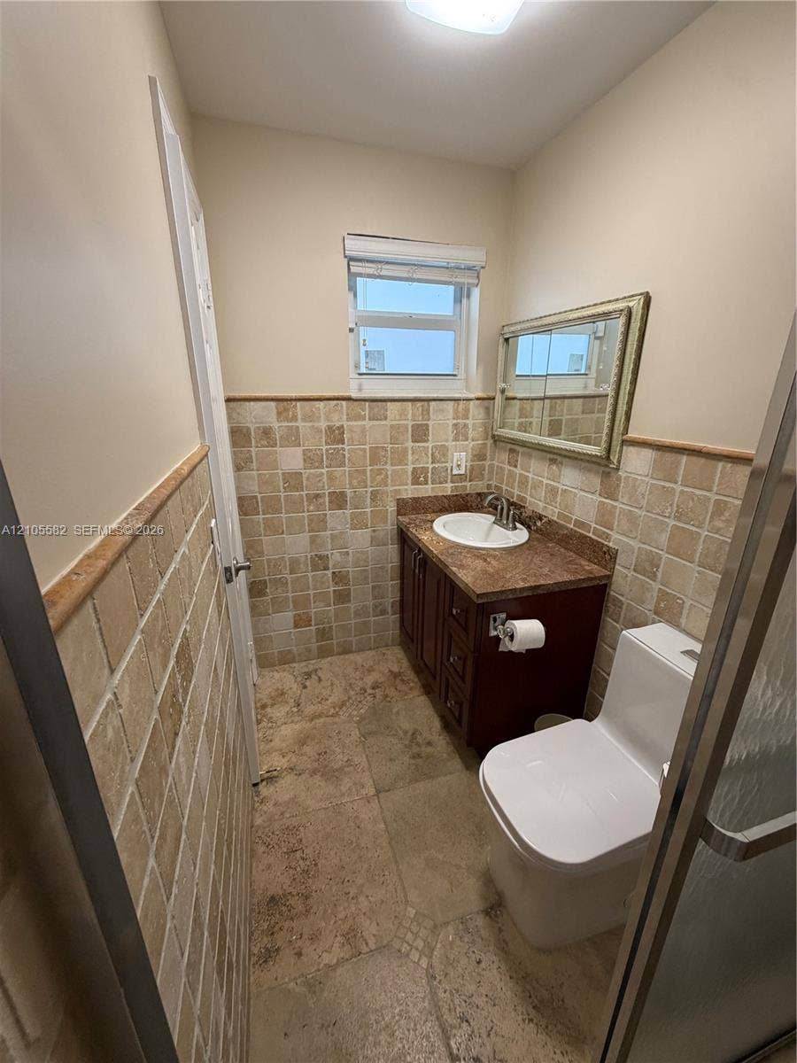 2215 NE 204th Street, Miami, Miami, FL 33180 Warm-toned tiled flooring complemented by mosaic wall tiling