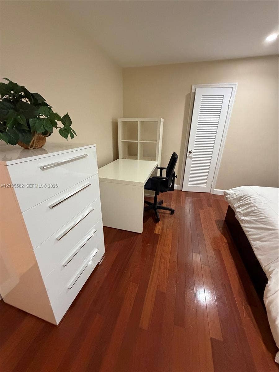 2215 NE 204th Street, Miami, Miami, FL 33180 Rich wood flooring, neutral wall tones, and a built-in louvered door