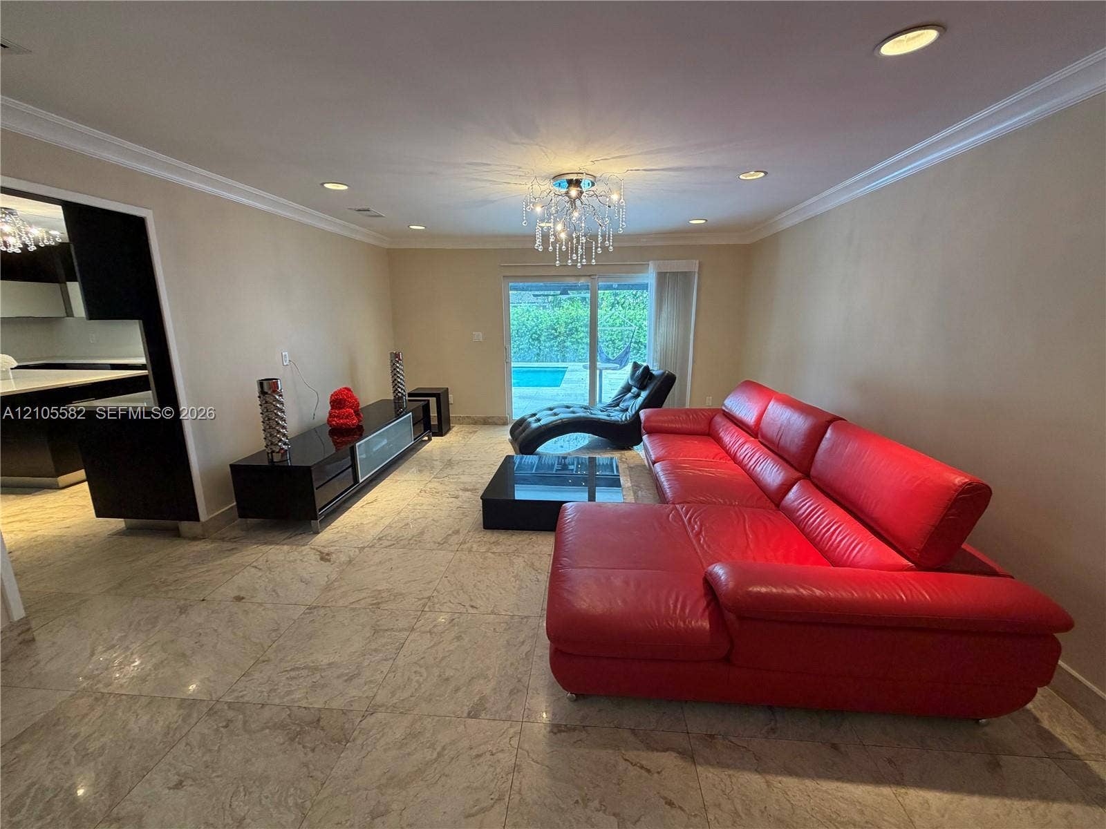 2215 NE 204th Street, Miami, Miami, FL 33180 Recessed lighting, crown molding, and a crystal chandelier illuminate the interior