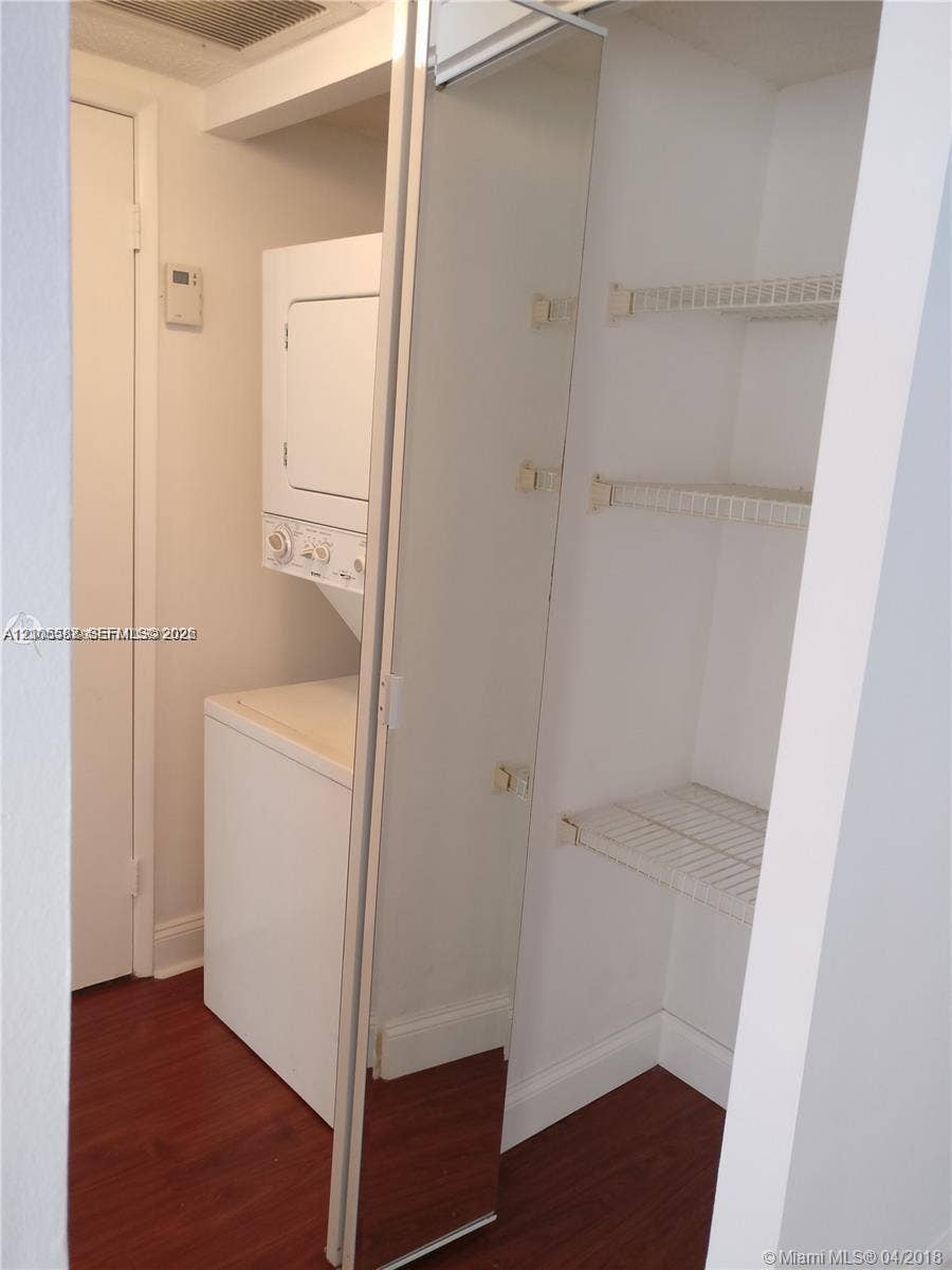 White stacked washer and dryer unit