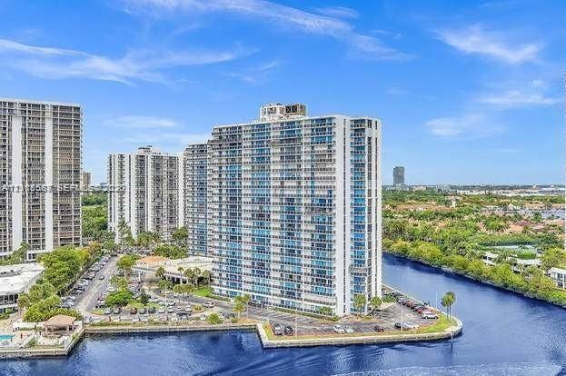 High-rise residential building featuring multiple stories and a prominent waterside location