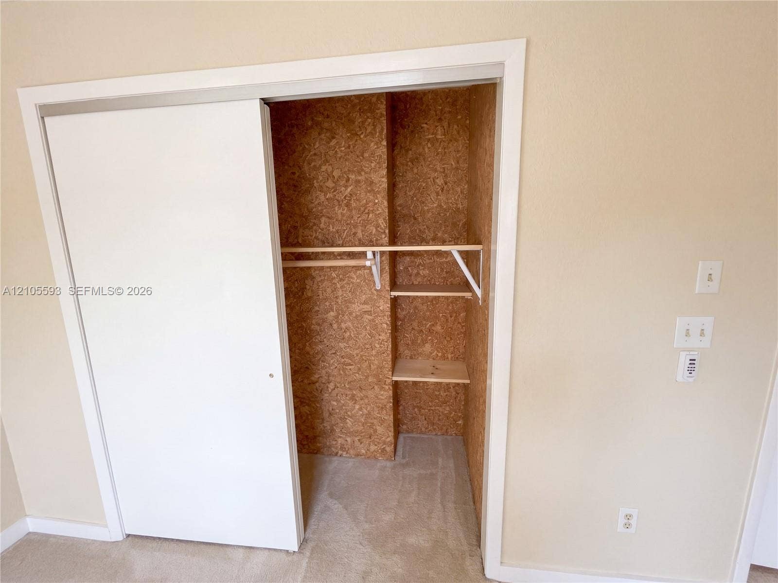 597 Grace Street, Sebastian, FL 32958 Sliding closet door with neutral wall finishes, interior storage shelving, and a wood-composite wall lining