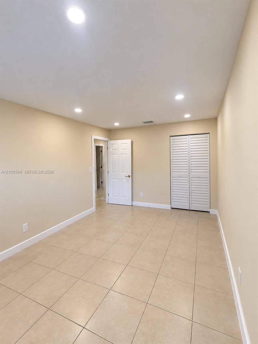 Recessed lighting, tile flooring, interior doors, and bi-fold closet doors