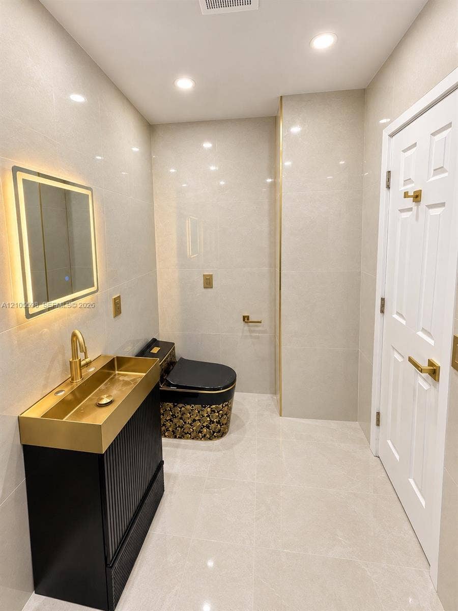 Contemporary vanity with a gold-finish basin and integrated faucet