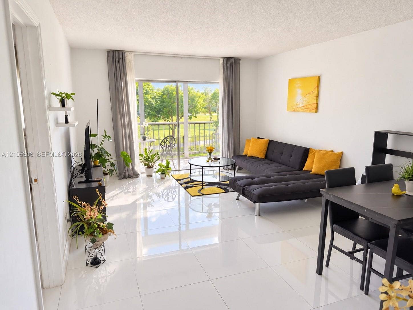 Polished tile flooring, sliding glass door, and outdoor balcony with metal railing