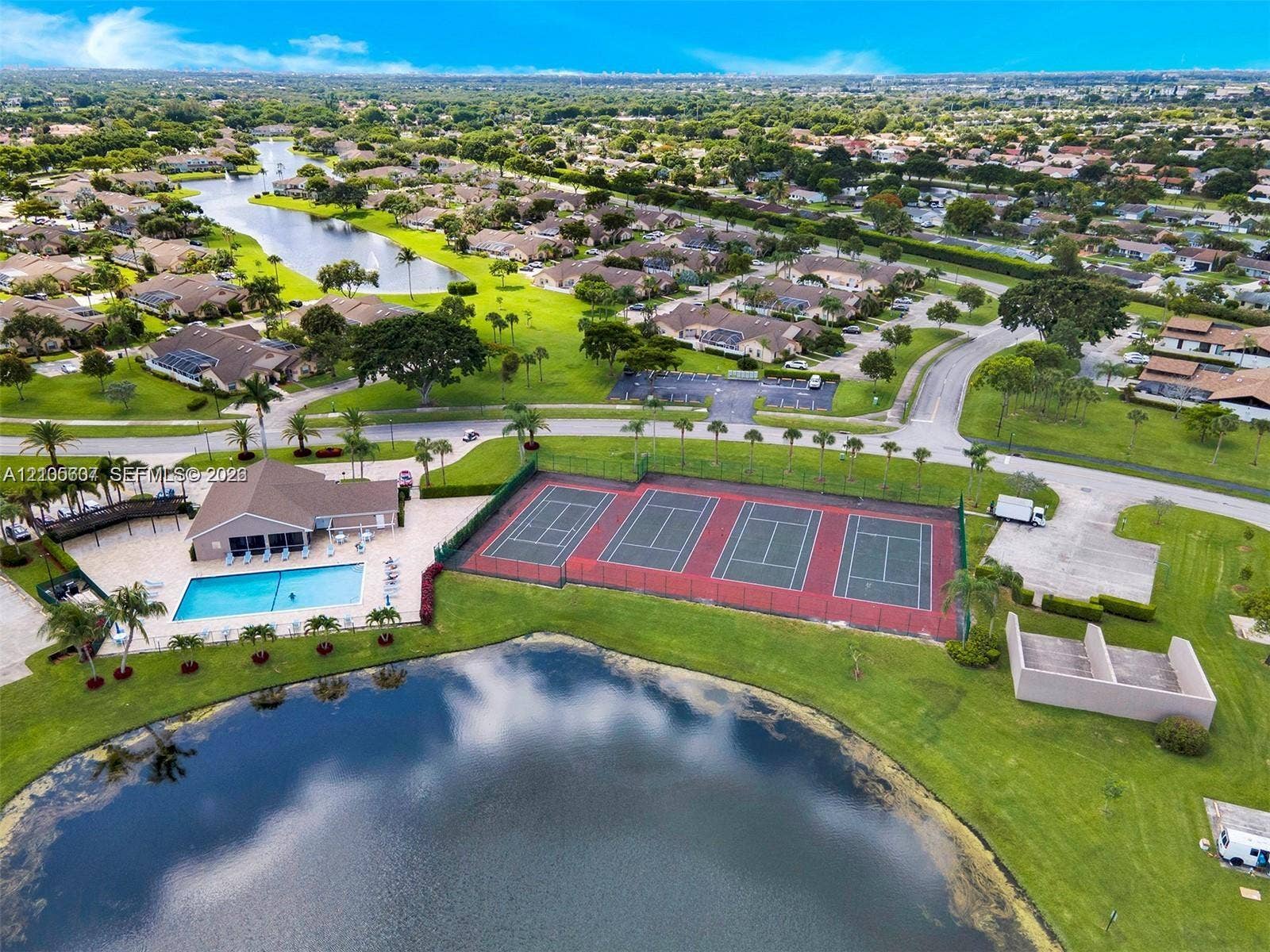 9892 Boca Gardens Parkway, #A, Boca Raton, FL 33496 Community amenities featuring a swimming pool, multiple tennis courts, and a clubhouse