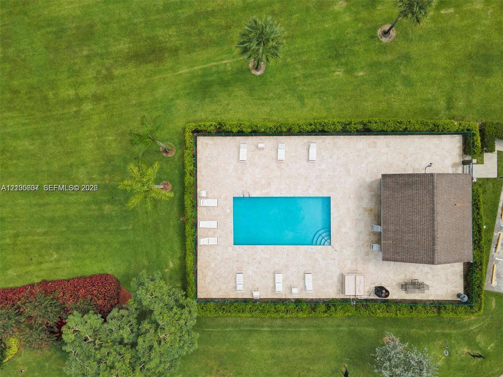 9892 Boca Gardens Parkway, #A, Boca Raton, FL 33496 Rectangular swimming pool with integrated steps, surrounded by a light-toned paved deck