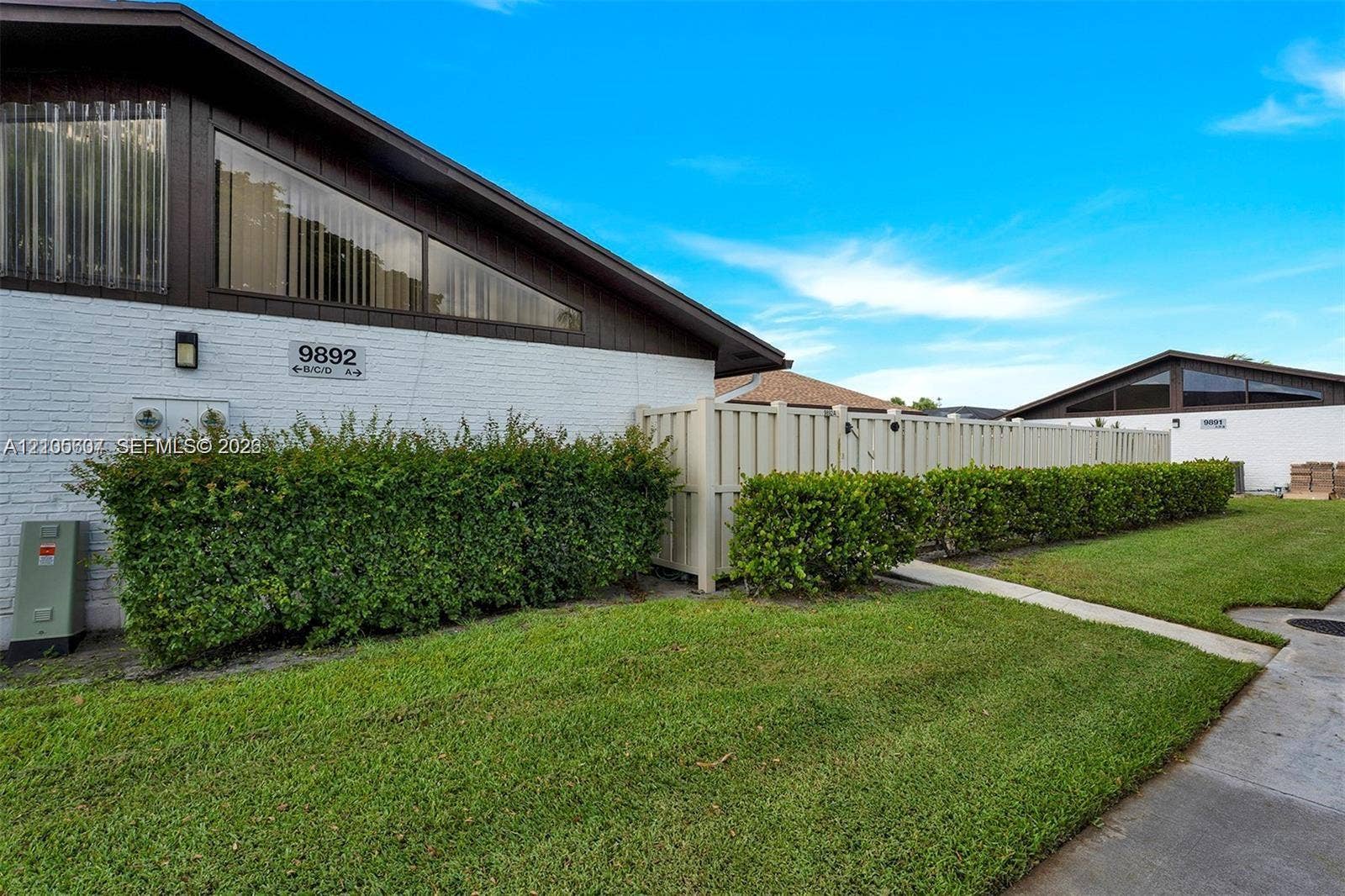 9892 Boca Gardens Parkway, #A, Boca Raton, FL 33496 White brick exterior with a dark trim