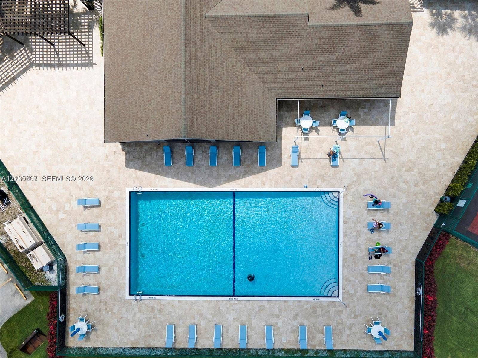 9892 Boca Gardens Parkway, #A, Boca Raton, FL 33496 Expansive pool area featuring a rectangular swimming pool, surrounding paver decking, and a covered patio area