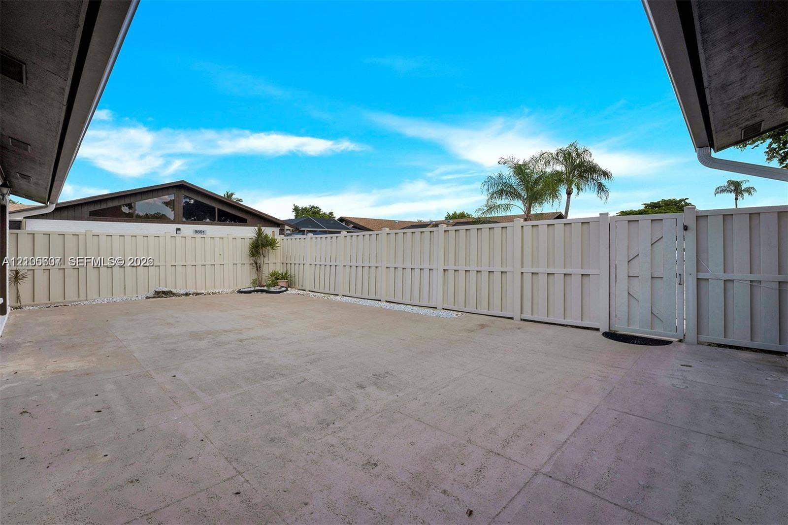 9892 Boca Gardens Parkway, #A, Boca Raton, FL 33496 Private outdoor space featuring a full-height perimeter fence, concrete ground surfacing, and a gated entry